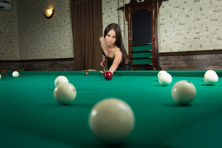 sexy girl in corset plays billiards 