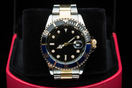 gold watch isolated on black backgroundの写真素材