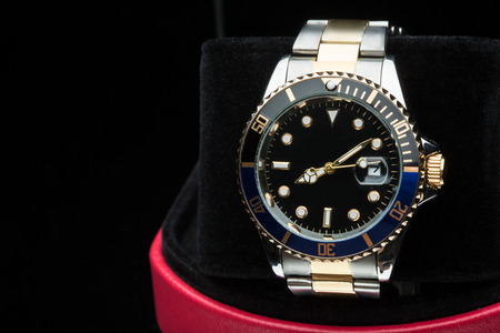 gold watch isolated on black backgroundの写真素材