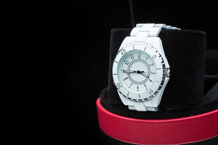 white clock on a black background.の写真素材