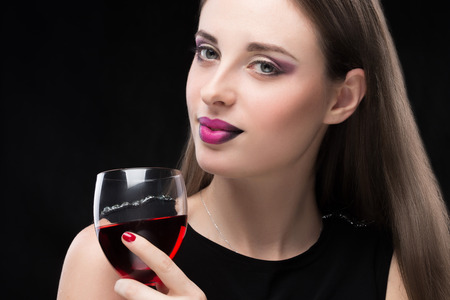 beautiful woman with glass red wineの写真素材