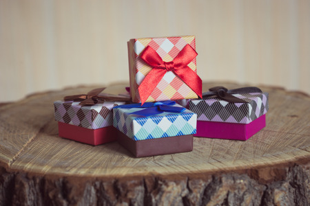 Gift box with red bow on wood backgroundの写真素材