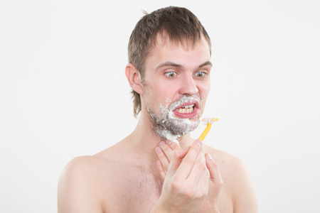 Sexy handsome young man with a shaving foamの写真素材
