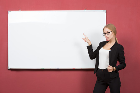 a portrait of business woman pointing at the whiteboardの写真素材