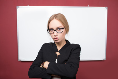 a portrait of business woman pointing at the whiteboardの写真素材