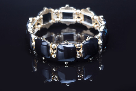 Bracelet with black  stones over black  background.の写真素材