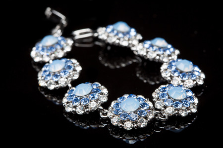 Bracelet with blue stones over black  background.の写真素材