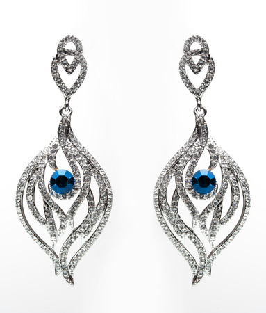 earrings with blue stones on the white backgroundの写真素材