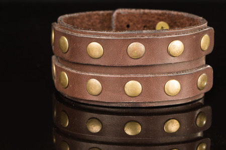 Brown leather bracelet isolated on a black backgroundの写真素材