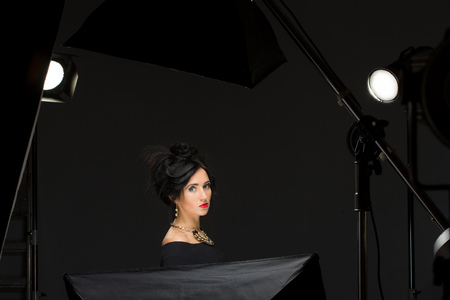 a beautiful girl sitting in the studio. lightingの写真素材