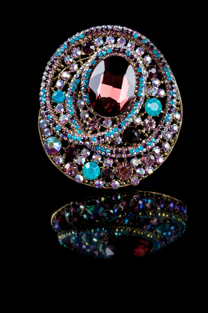 jewellery brooch isolated on black background. multicoloredの写真素材