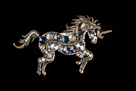 brooch in the form of a unicorn on a black background