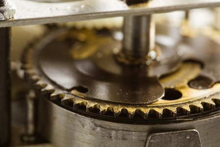 Antique clock gears. the yellow metal with a blurred background