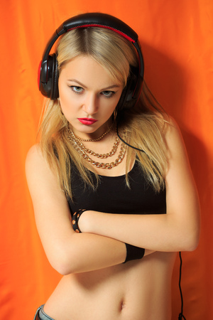 young pretty hipster woman listening music and dancing. big headphones on your phoneの写真素材