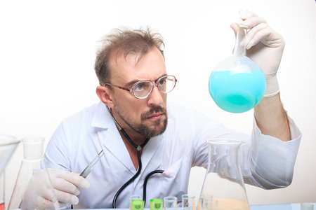 Mad chemist in the lab doing reaction - studio shootの写真素材