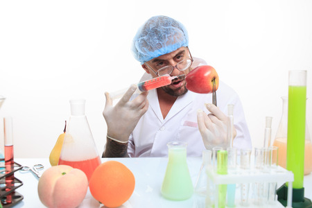 scientist fills chemicals fruit and vegetables. chemistry