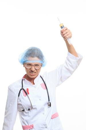 evil doctor with big syringe on a white backgroundの写真素材