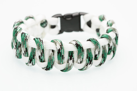 white green braided bracelet on white background.  synthetic cordの写真素材