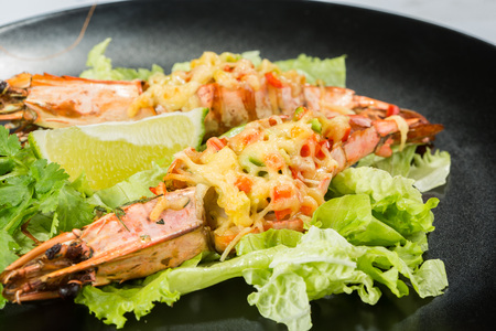 perfect dish with shrimps on a black plate.の写真素材