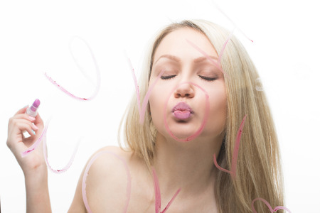 Young beautiful girl written on a mirror in lipstick, I love you. and lipstickの写真素材