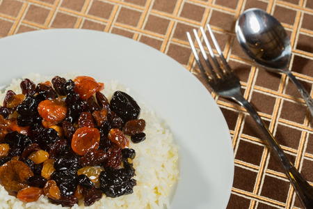 Vegetarian sweet rice with dried apricots and raisins close-up on the table. dietary foodの写真素材