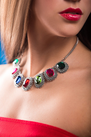 necklace on the neck. colored gems. blue backgroundの写真素材