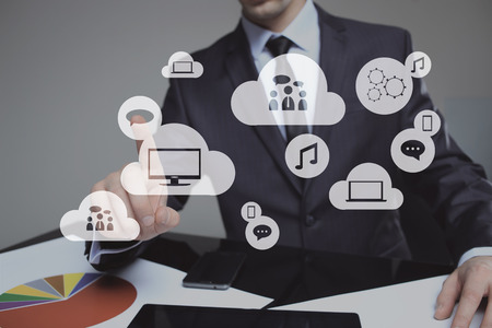 Businessman pressing high tech glowing modern cloud service interface touch screen buttonの写真素材