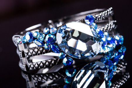 Bracelet with blue stones over black. close-upの写真素材