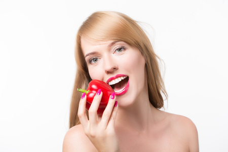 beautiful young woman with paprika, on a white backgroundの写真素材