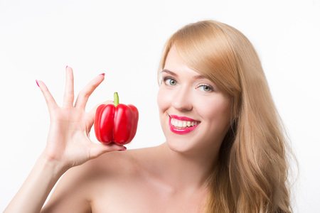 beautiful young woman with paprika, on a white backgroundの写真素材