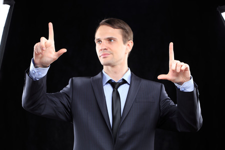 Young executive man touching an imaginary screenの写真素材