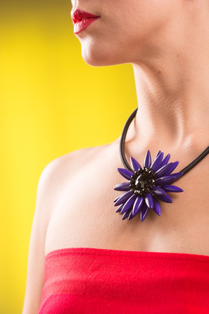 necklace on the neck. colored gems. blue backgroundの写真素材