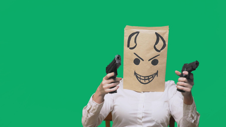 concept of emotion, gestures. a man with a package on his head, with a painted smiley angry, sly,...