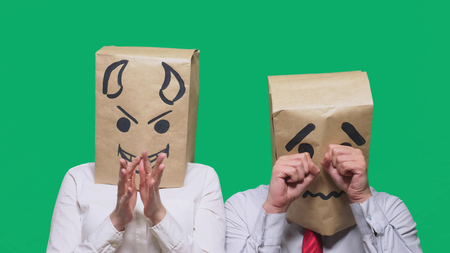 concept of emotion, gestures. a man with a package on his head, with a painted smiley crying, sad,の写真素材