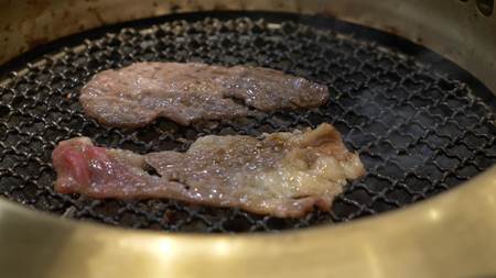 Korean barbecue grill. people cook and eat dishes cooked on a Korean grill in a restaurant. close-up