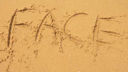 The sea wave erases the inscriptions written on the sand. top view.の写真素材