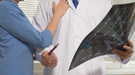 Harassment in the hospital. the doctor solicits his colleague during the analysis of the results of magnetic-resonance therapyの写真素材