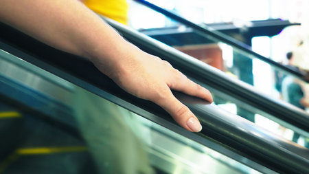 movement of the woman's hand on the escalator handrails. 4k, slow-motion, close-up.