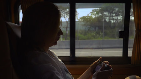 a woman uses the phone while sitting in the passenger seat of a minivan.