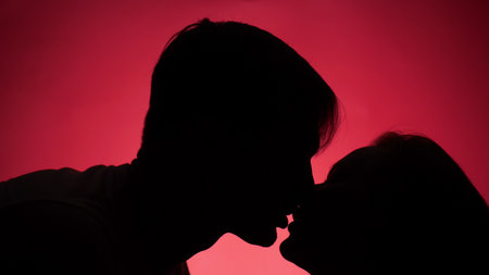 color background. shadow of a man. couple, man and woman kissingの写真素材