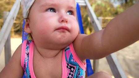 close-up, portrait of a little one year old babe on the beach.の写真素材
