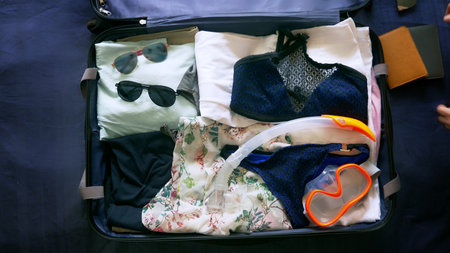 close-up. a couple of hipsters collects a suitcase on vacation in warm countries, a diving gearの写真素材