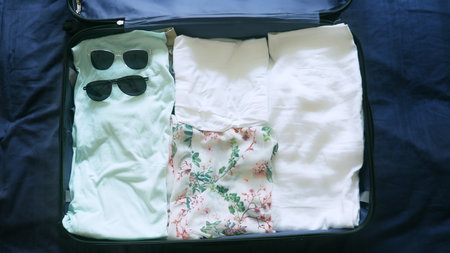 close-up. girl collects a suitcase for rest in warm countries with scuba diving gear in the sea
