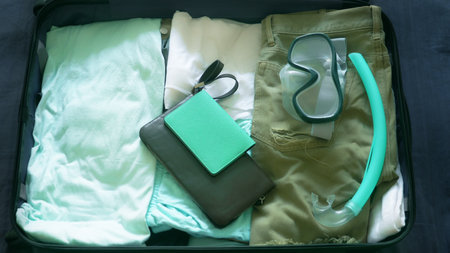 close-up. man collects a suitcase on a trip to tropical countries with diving equipment in the seaの写真素材