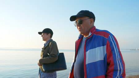 Senior couple walking at the beach on the northern sea. Spending time together.の写真素材