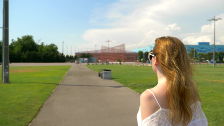 The girl alone goes on the road in a large desert parkの写真素材