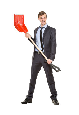 allegory. office worker, manager, tortured businessman in suit and tie with a shovel on a white backgroundの写真素材