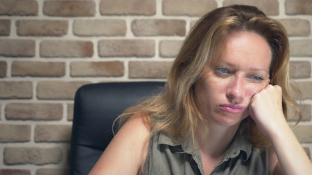 creative crisis concept, blocking ideas. annoyed woman sitting at a laptop in a modern loft.の写真素材