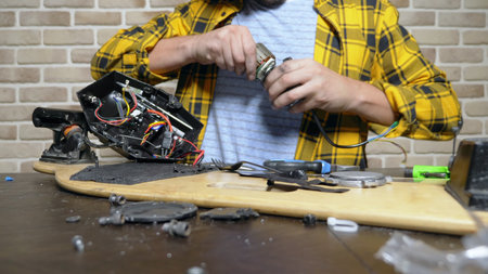 mechanic repairing an electric motor of an electric skate. bearing close up.
