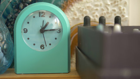 green alarm clock on a shelf in the artist's creative studio